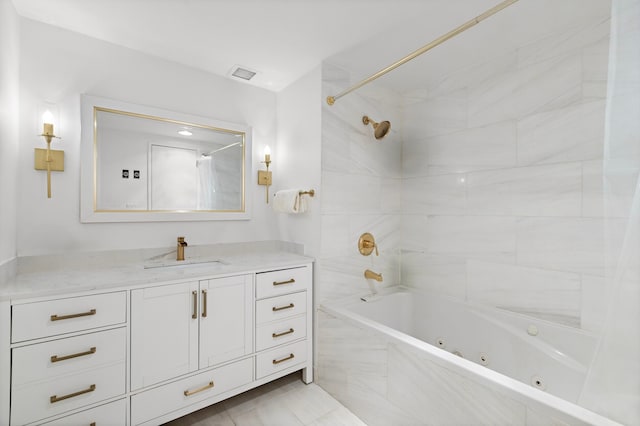 full bath with vanity, a combined bath / shower with jetted tub, and visible vents