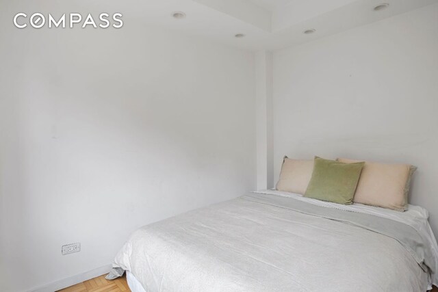 bedroom featuring parquet flooring