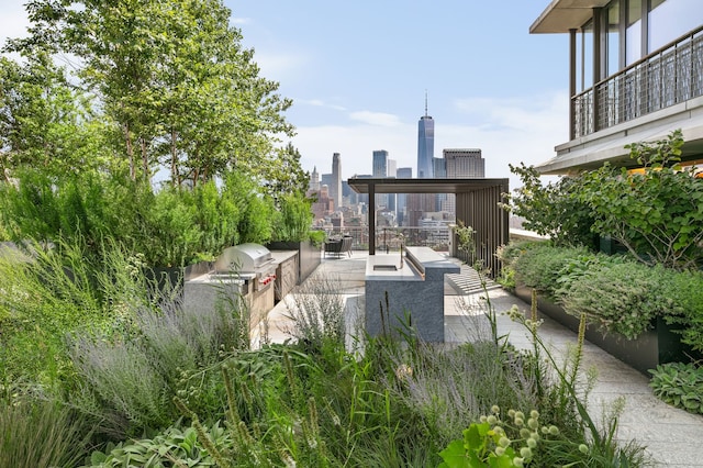 100 Vandam St Unit 20-A, New York City, NY 10013 - view of patio featuring exterior kitchen, a city view, and a balcony