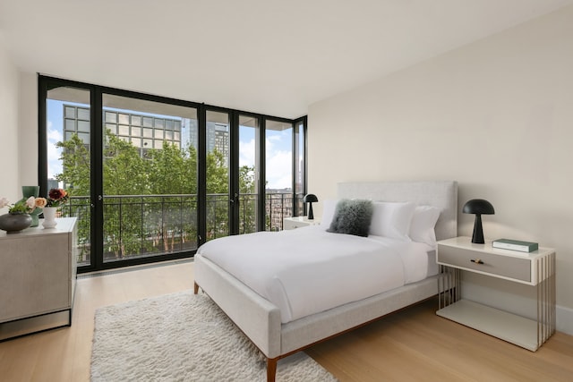 100 Vandam St Unit 20-A, New York City, NY 10013 - bedroom with expansive windows, wood finished floors, and multiple windows