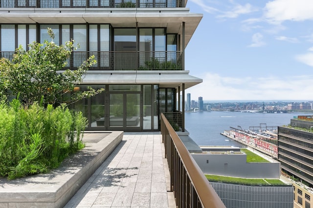 100 Vandam St Unit 20-A, New York City, NY 10013 - rear view of property with a balcony, a water view, and a city view