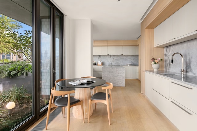 100 Vandam St Unit 20-A, New York City, NY 10013 - dining space featuring light wood finished floors