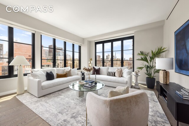 living room featuring baseboards and wood finished floors