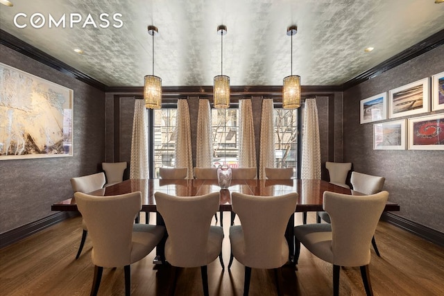 dining space featuring ornamental molding, wood finished floors, and baseboards