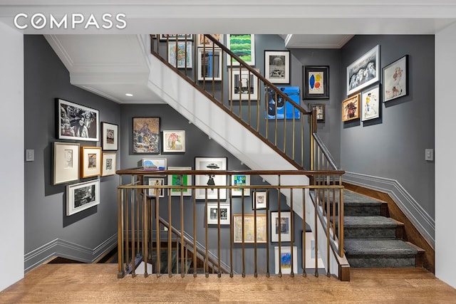 stairway with baseboards and crown molding