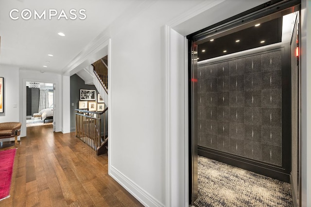 hall with baseboards, stairway, wood finished floors, and recessed lighting