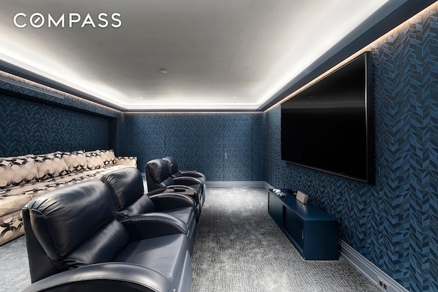 carpeted cinema room featuring wallpapered walls and baseboards