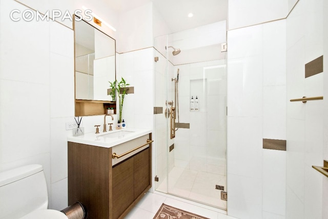 bathroom with vanity, toilet, and a shower with shower door