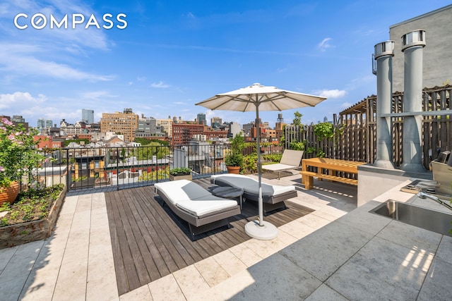 view of patio featuring a view of city and a sink