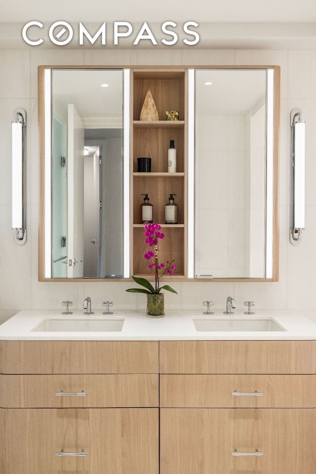 full bath with double vanity and a sink