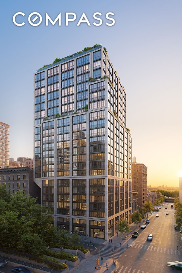 property at dusk with a city view