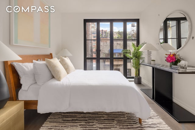 bedroom featuring wood finished floors and baseboards