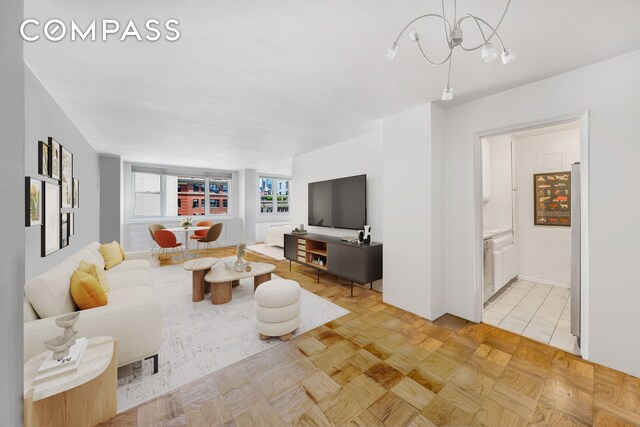 interior space with light parquet floors and a chandelier