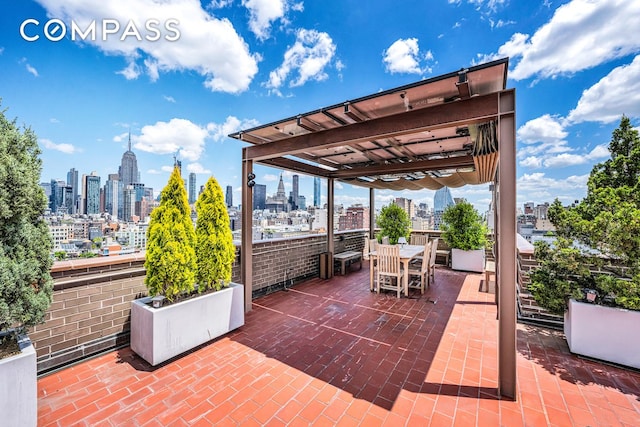 view of patio with a view of city, outdoor dining area, and a pergola