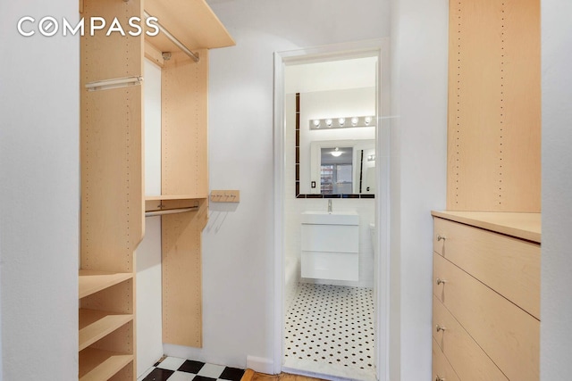 walk in closet featuring light floors