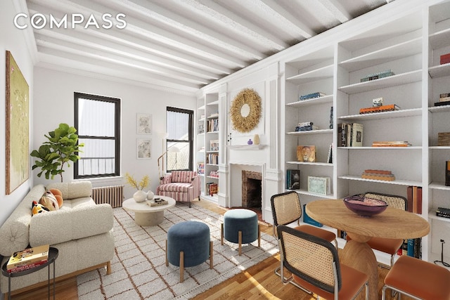 living room with built in features, radiator, and light hardwood / wood-style flooring