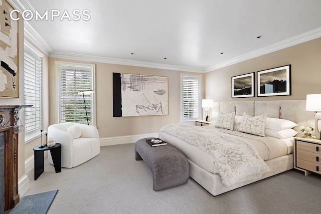 bedroom with baseboards, carpet, a high end fireplace, and crown molding