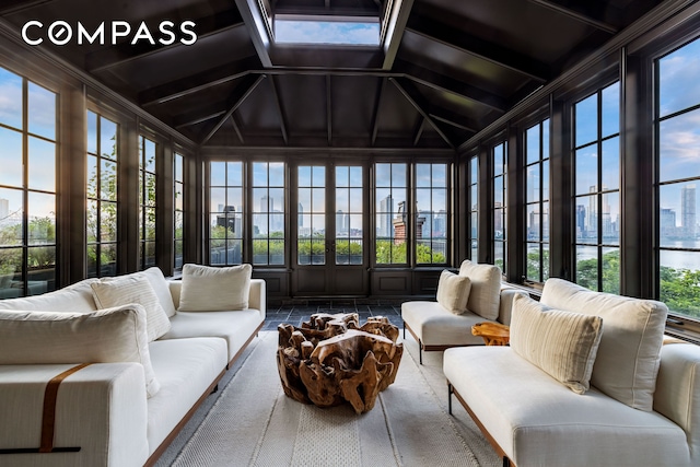 sunroom / solarium featuring tile patterned floors, french doors, and vaulted ceiling