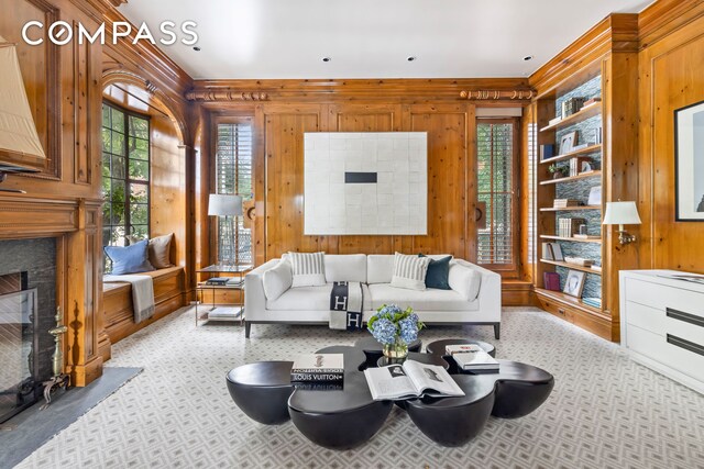 21 Beekman Place, New York City, NY 10022 - living room featuring wooden walls, a fireplace with flush hearth, and carpet