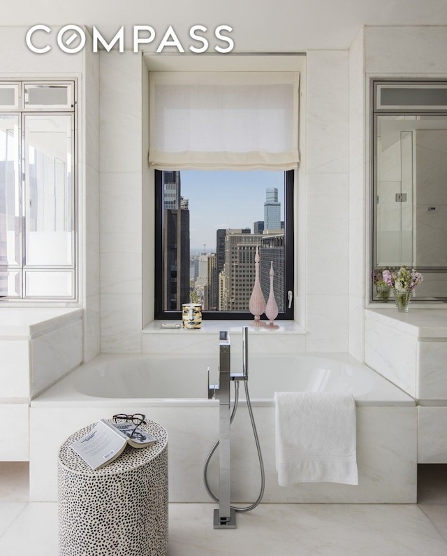 full bathroom featuring a bathing tub and a wealth of natural light