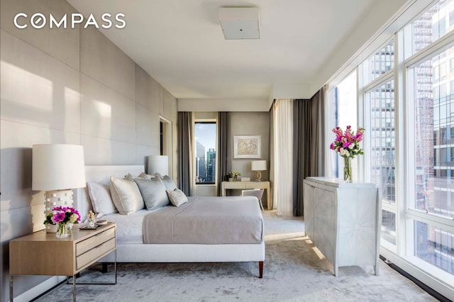 bedroom featuring light colored carpet