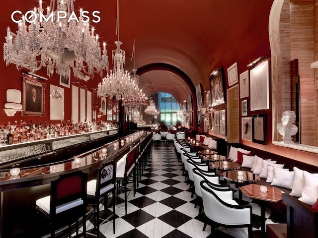 20 W 53rd St Unit 42A, New York City, NY 10019 - indoor dry bar with a chandelier, arched walkways, and lofted ceiling