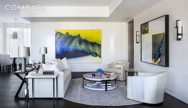 living room featuring wood finished floors and baseboards