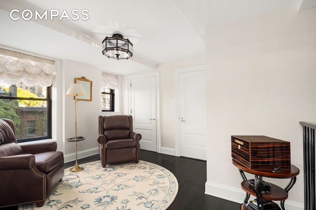 sitting room featuring baseboards and wood finished floors