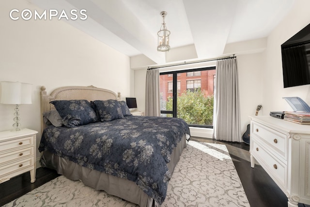 bedroom featuring beam ceiling and dark wood-style flooring