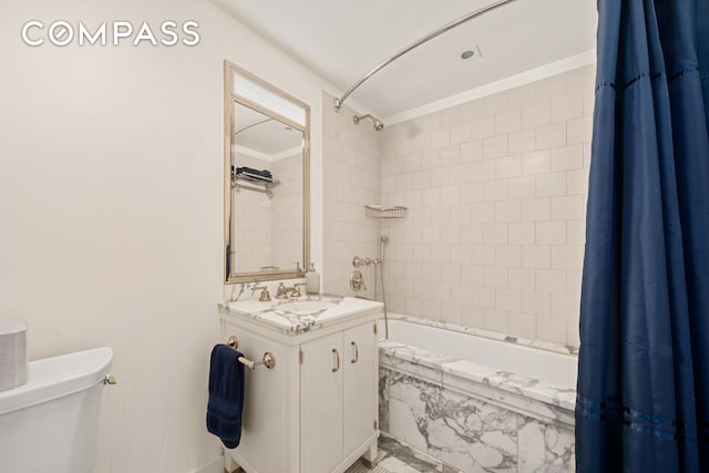 bathroom featuring toilet, shower / bathtub combination with curtain, and vanity