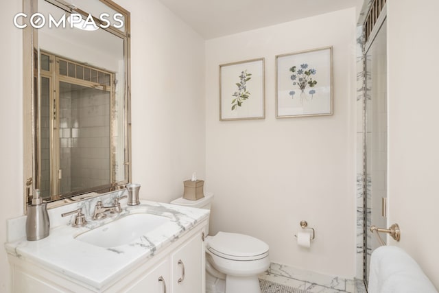 bathroom with marble finish floor, baseboards, vanity, and toilet