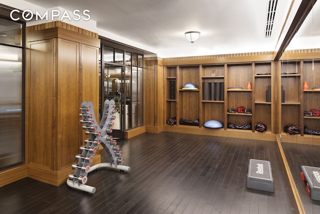 workout room featuring dark wood-type flooring