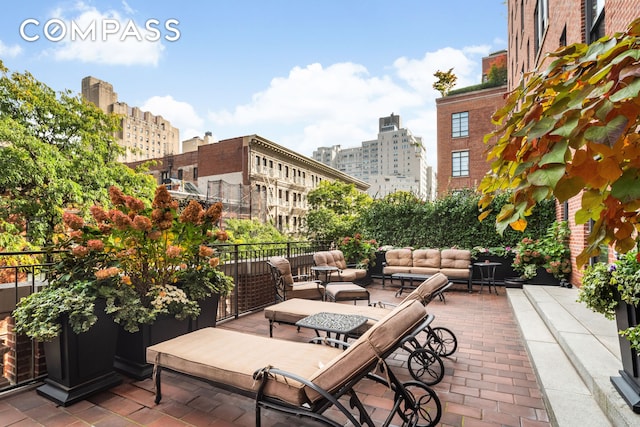 view of patio / terrace featuring a view of city and an outdoor hangout area