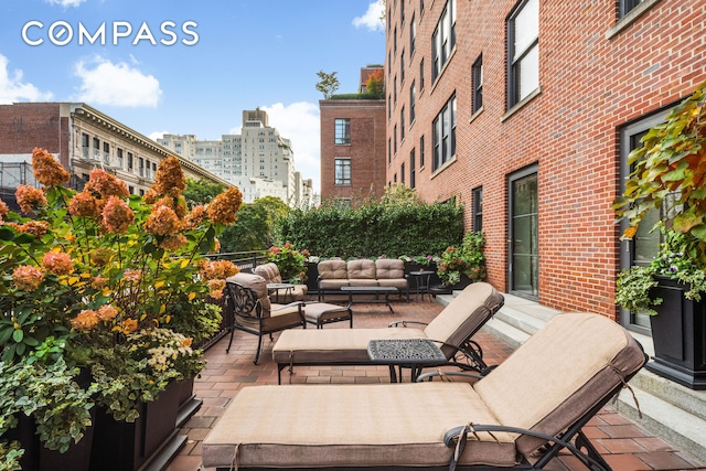 view of patio / terrace with a view of city and an outdoor hangout area