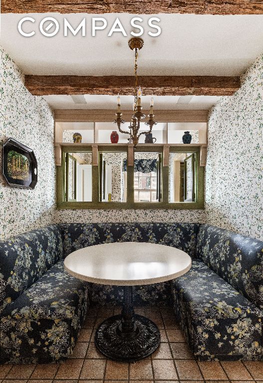 interior space featuring beam ceiling and wallpapered walls