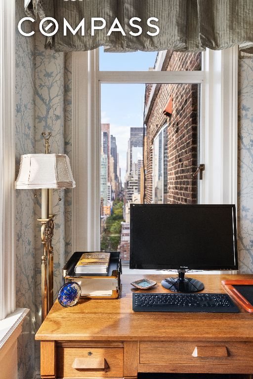 home office with wallpapered walls