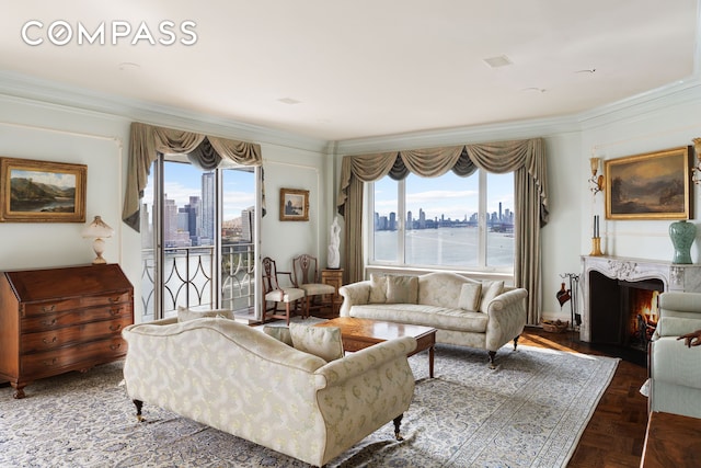 living area with crown molding, a view of city, and a high end fireplace