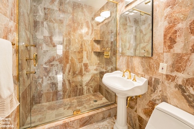 bathroom featuring toilet, a shower stall, and tile walls