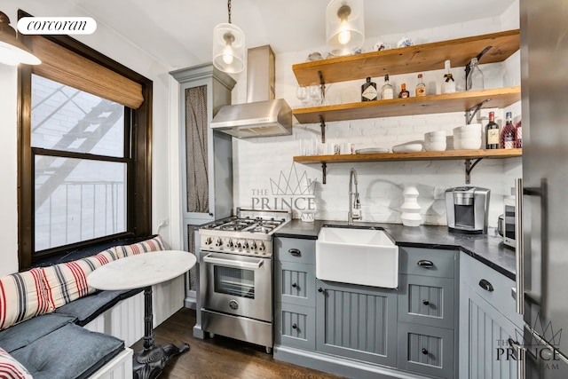 kitchen featuring dark countertops, gray cabinetry, stainless steel appliances, and open shelves