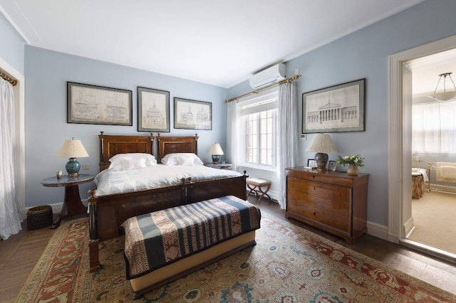 bedroom featuring dark hardwood / wood-style flooring and a wall mounted AC