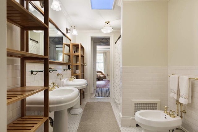 bathroom featuring tile patterned floors, crown molding, a skylight, tile walls, and a bidet