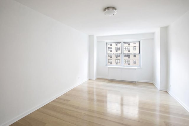 spare room featuring light wood-type flooring