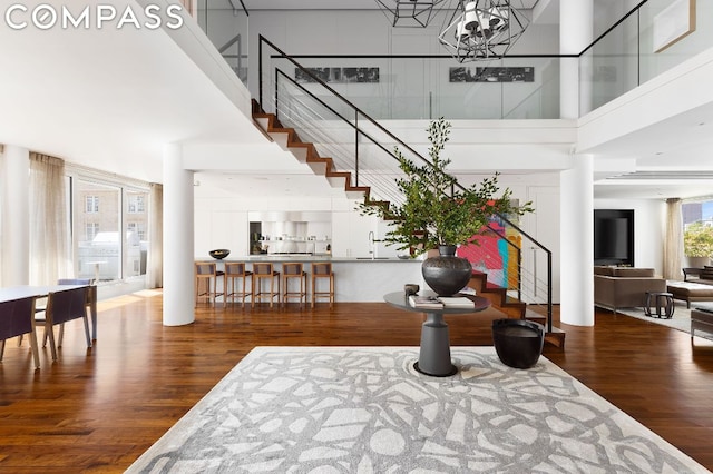 entryway with hardwood / wood-style floors, a chandelier, and a high ceiling