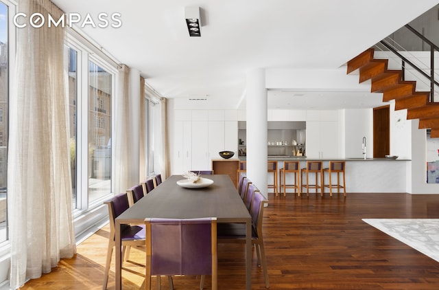 dining area featuring stairs and wood finished floors