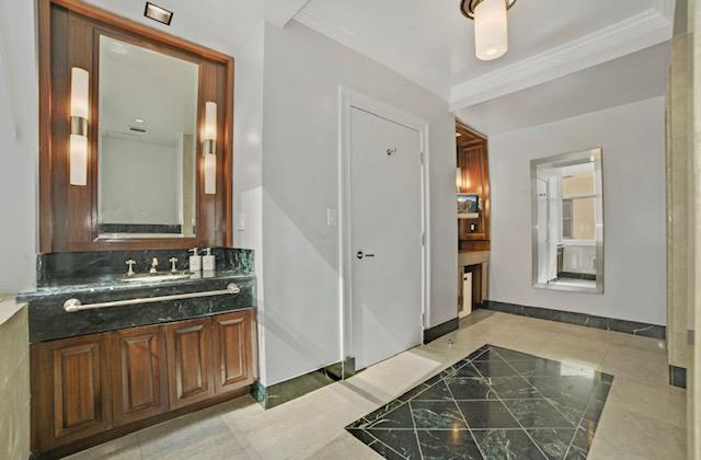 bathroom with tile patterned flooring, ornamental molding, and vanity