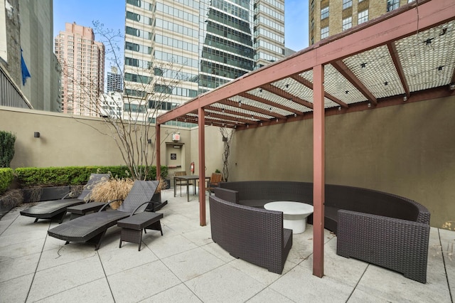 view of patio with a view of city, an outdoor hangout area, and a pergola