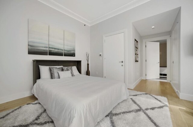 bedroom with baseboards and wood finished floors