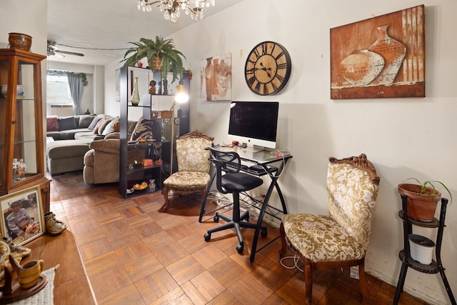 office space with ceiling fan with notable chandelier