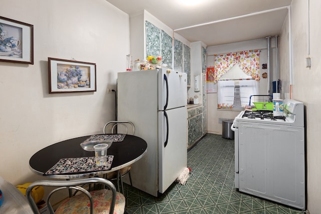 kitchen featuring dark floors and white appliances