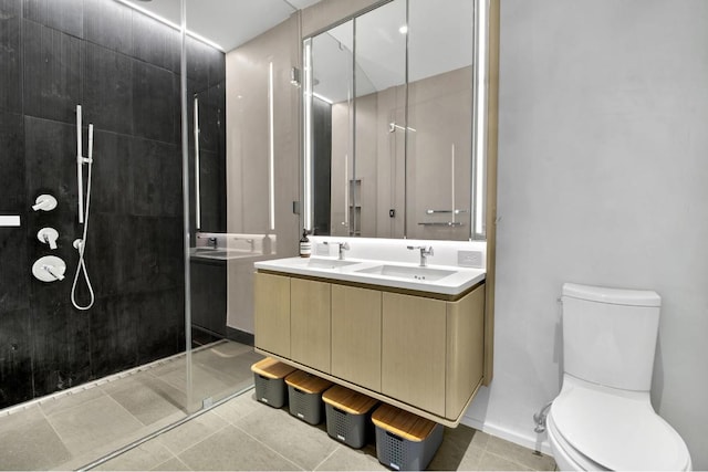 bathroom featuring walk in shower, vanity, tile patterned floors, and toilet